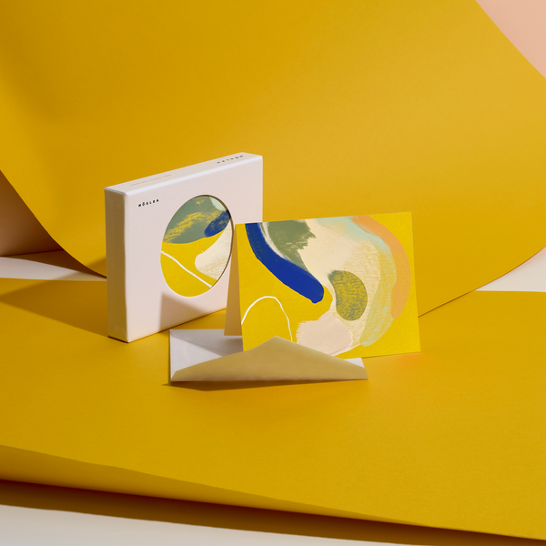 Moglea Canary Stationery Set featuring colorful notebooks, pens, and paper with vibrant canary bird illustrations.