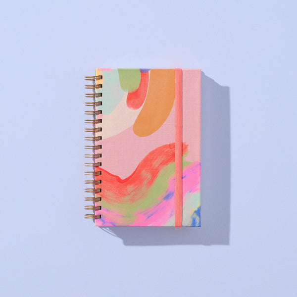 Small A6 notebook by Moglea featuring a textured cover and lined pages, perfect for jotting down notes and ideas.