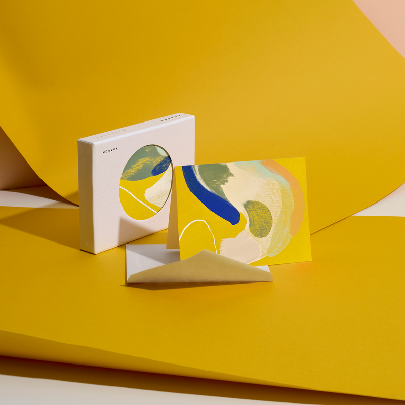 Moglea Canary Stationery Set featuring colorful notebooks, pens, and paper with vibrant canary bird illustrations.