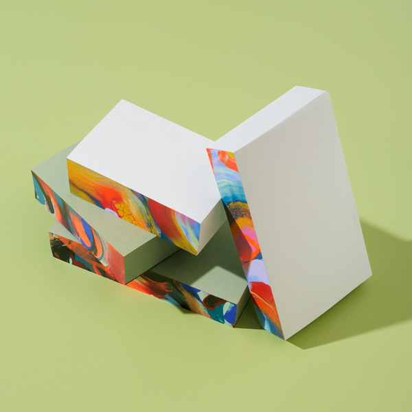 Small Moglea Supernova Swirl Pad notepad with colorful, spiral design and textured paper for writing and note-taking.