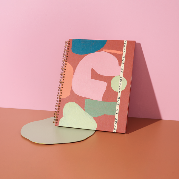 Moglea Sierra Composition B5 Notebook with cream-colored pages and black spiral binding, designed for writing and note-taking.
